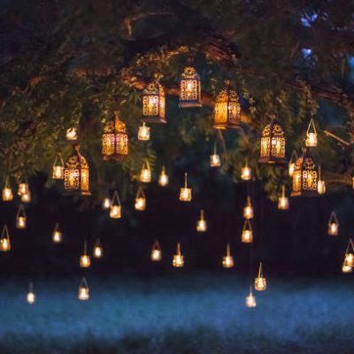 Night wedding ceremony with a lot of vintage lamps and candles on big tree Night wedding ceremony with a lot of vintage lamps and candles on big tree